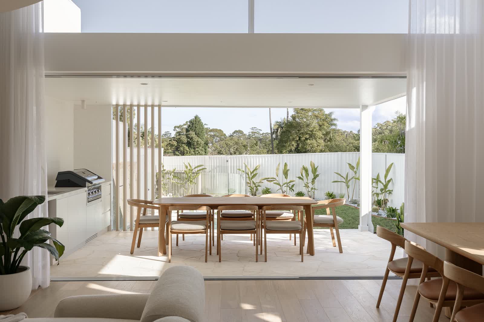 Covered alfresco dining opening onto the garden