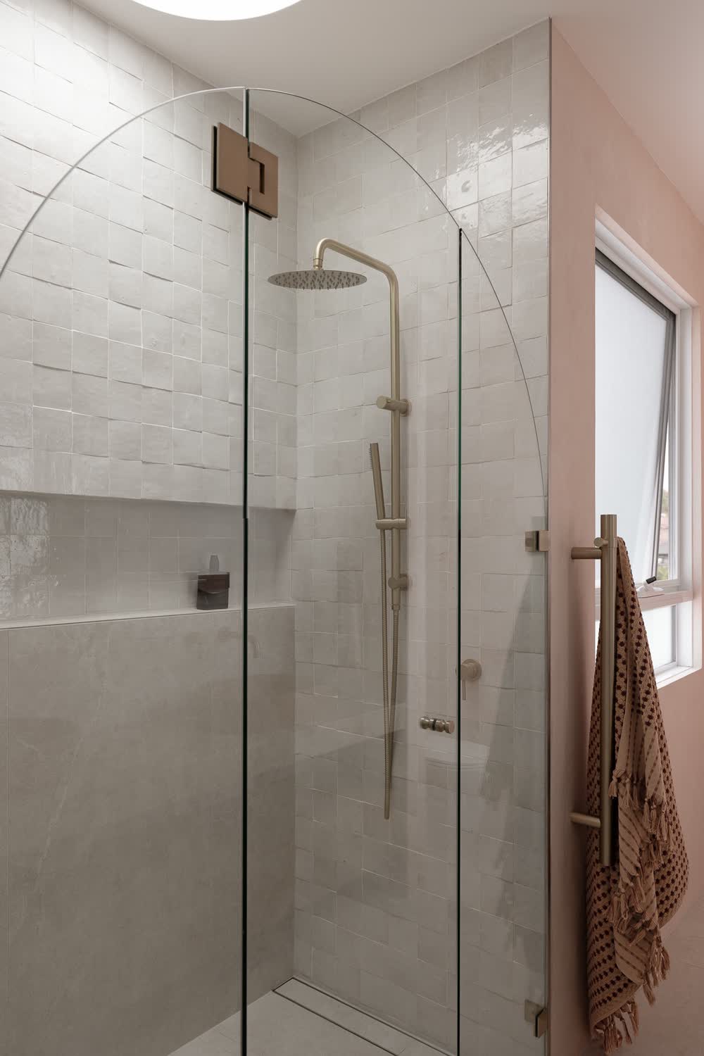 Ensuite with an arched glass shower screen