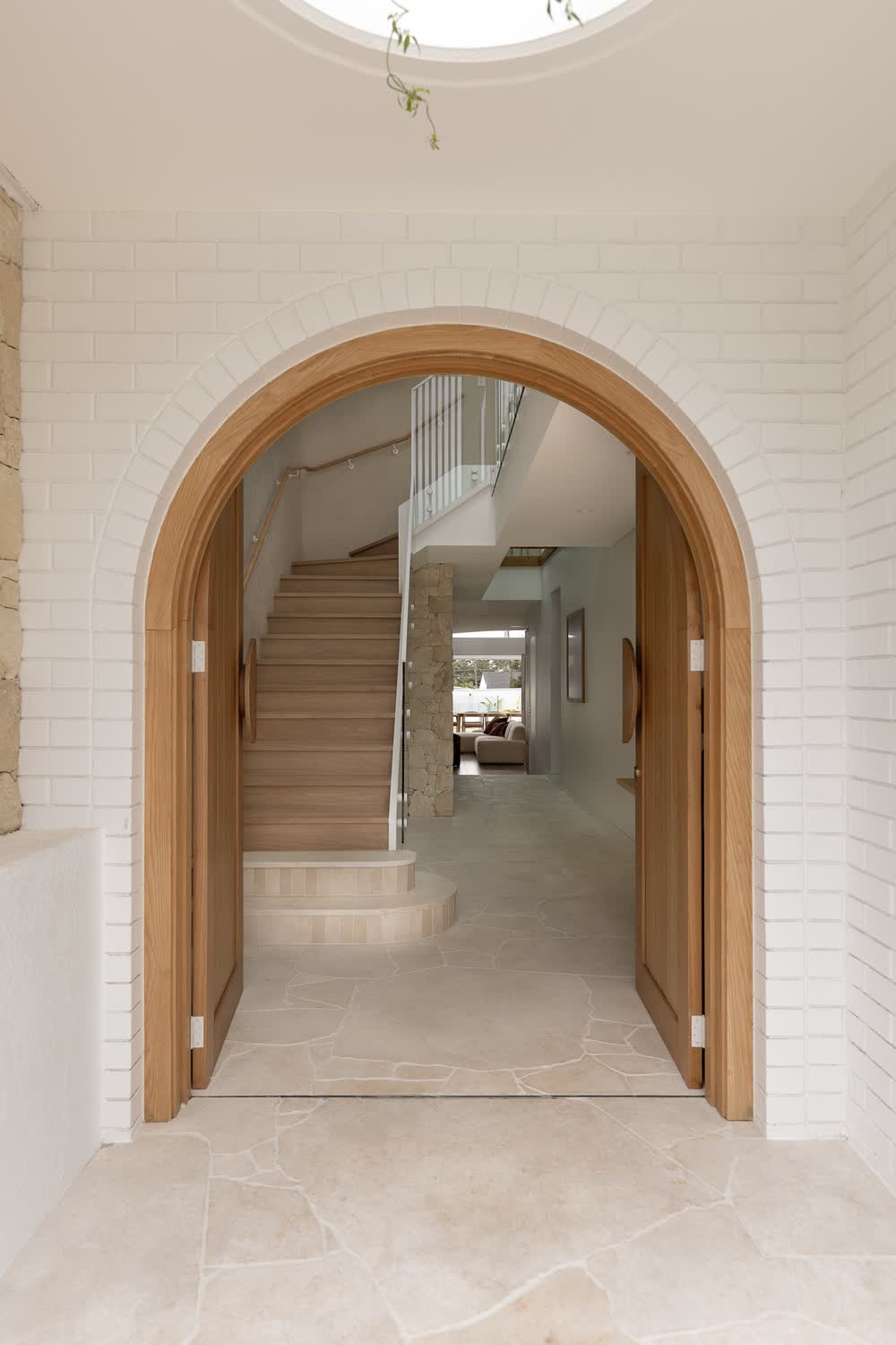 Arched timber front doors opening to the entry and stairs