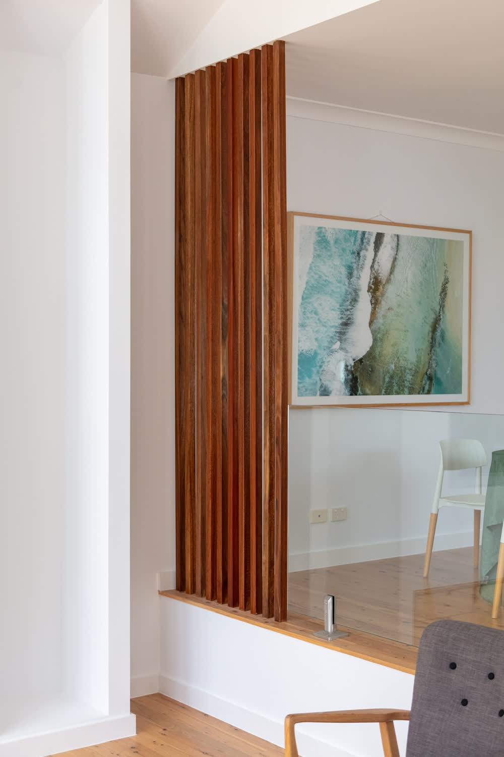Timber battens screening the step up into the extension