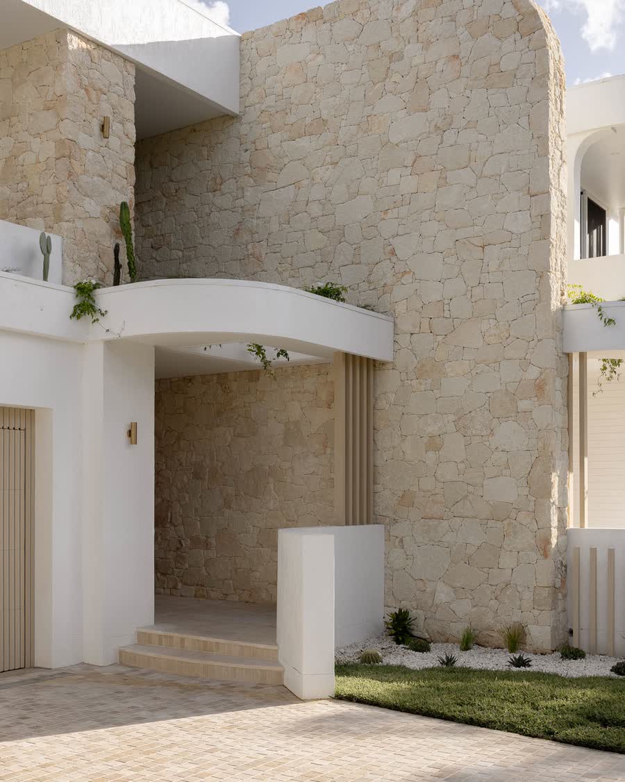 Sandstone and white render entry of a New Living custom duplex