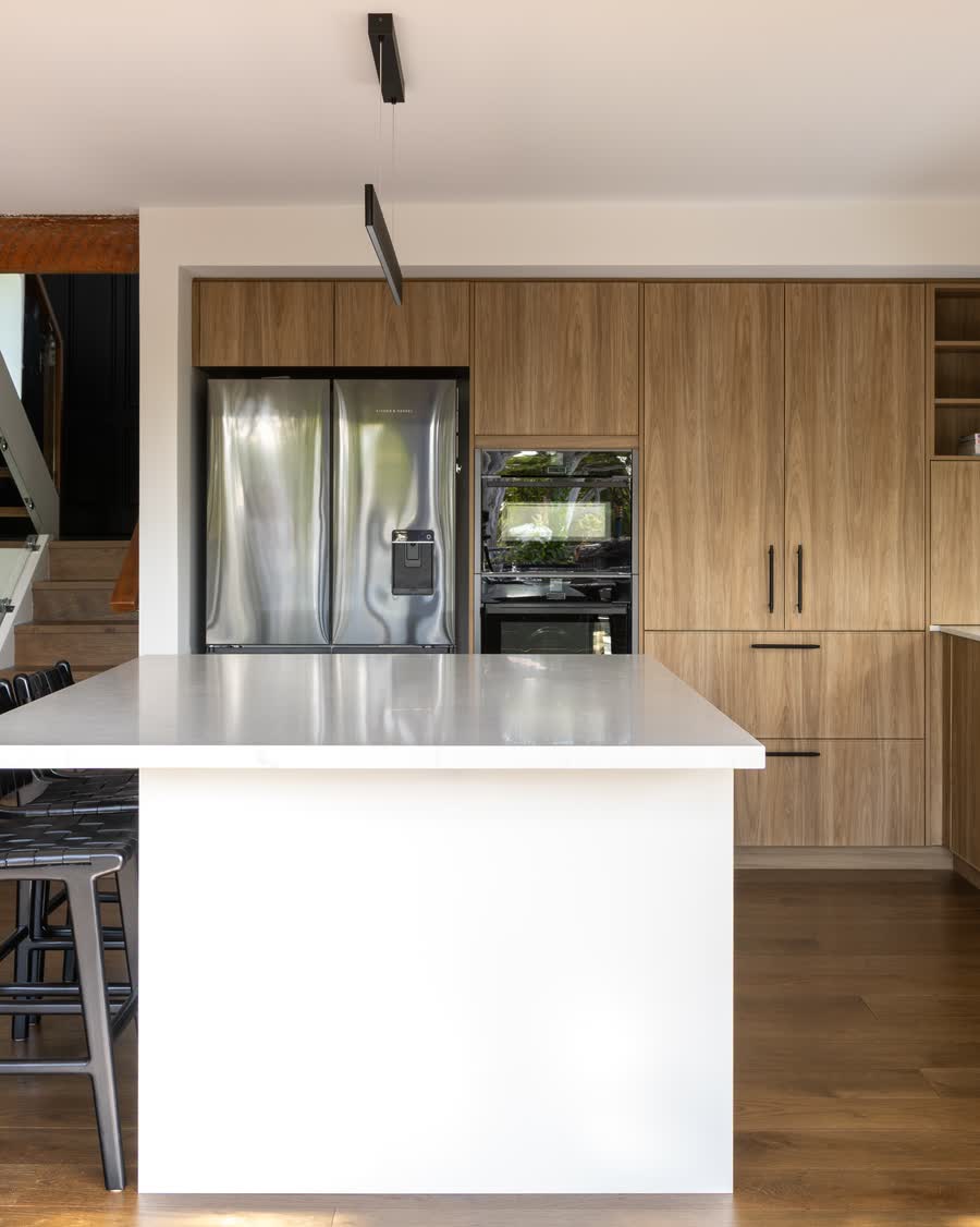 Renovated open-plan kitchen with timber cabinetry and a white island